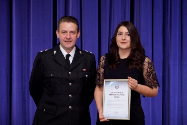 Sergeant Simon Edwards presenting the award to Bernadette Light