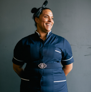 A portrait photo of Siobhan Taylor in her uniform. She is looking out of shot to the right and smiling.