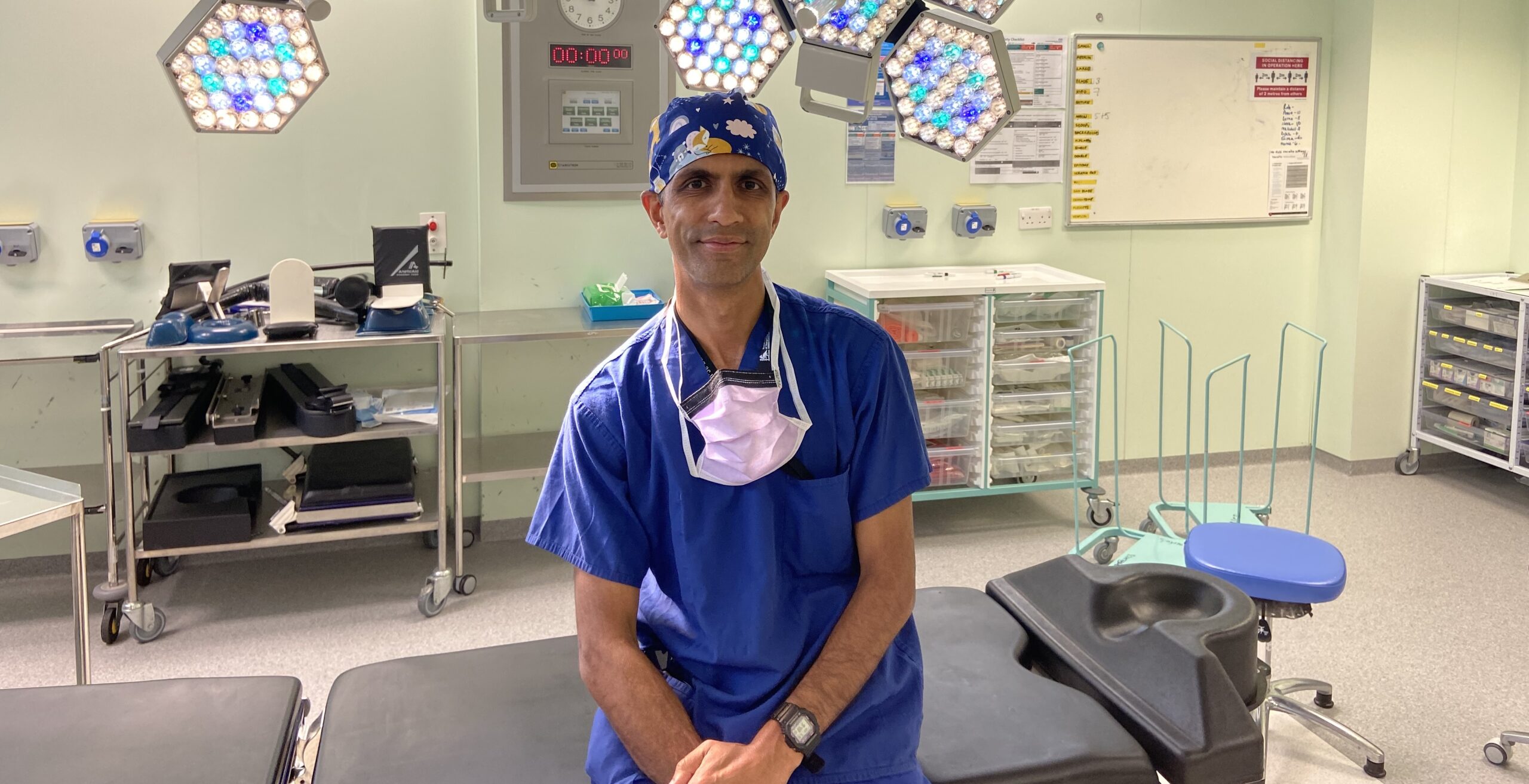 Photo of Doctor Aneel Bhangu in scrubs at University of Birmingham hospital.