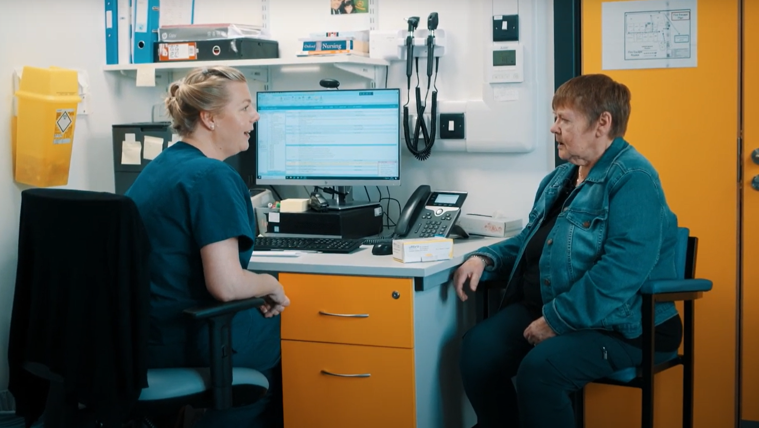 Photo of a doctor speaking to a patient at the Kirkholt Medical Centre in Rochdale