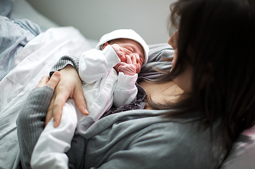 Mum holding newly born baby