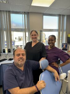Bill Orliaklis, Sarah Fletcher and foundation dentist Tendai Mukahadira in a dental consultation room