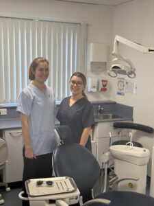 Dentist Kate Waldon stood in a dental consultation room alongside colleague Rachael Bale