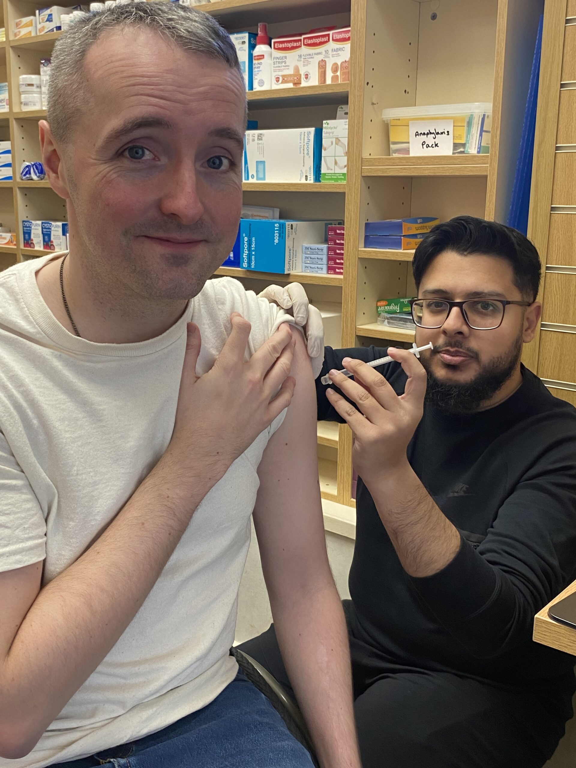 NHS England’s Senior Communications Manager, Joshua Gardner, receives his flu vaccination from Trainee Pharmacist Ali Khan at Halton Pharmacy in Leeds.