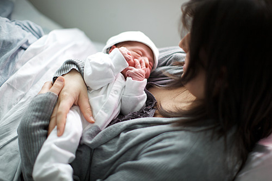 A mother holding her newborn