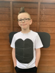 Mike, 10, posing for the picture with his hands in his pockets, sporting a mohican hair cut, smiling