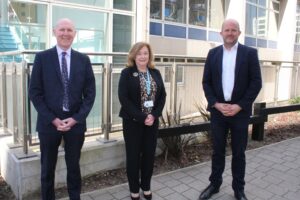 David Webb, Chief Pharmaceutical Officer for NHS England, stands with Alison Ewing and Richard Cattell