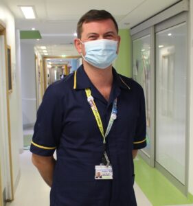 mAN IN SCRUBS WEARING MASK