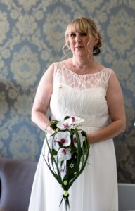 Woman in wedding dress holding flowers