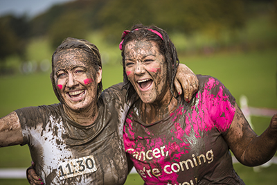 Two women taking part in a cancer charity event