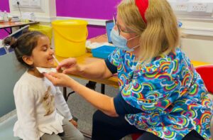 Alana receiving her flu vaccination