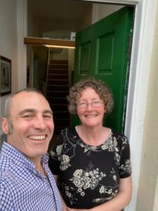 a man and a woman taking a selfie in a doorway