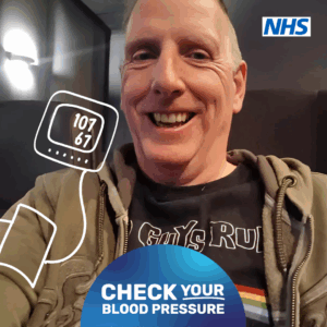 Photograph of a man with an illustration of a blood pressure cuff which shows his blood pressure reading which is 107/67. The NHs logo is in the right hand top corner and at the bottom of the page a blue semi circle with the words Check Your Blood Pressure are written in white.