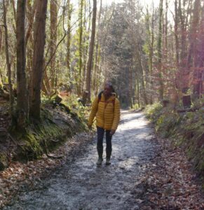A woman walking in woods 