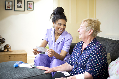 A care worker pays a home visit to a patient