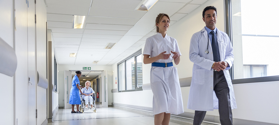 NHS staff walking down a corridor