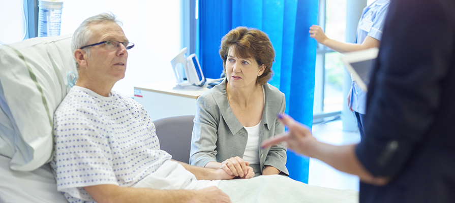 A man and his wife talk to a doctor