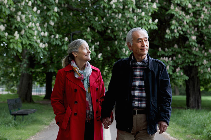 A couple go for a walk in a park