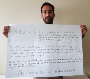 picture of Dr Ilan Ben-Zion holding a message that reads: Mental Health: This is something we all have. It is a neutral term and does not mean we have good or bad mental health. If you have blood, you have mental health. The #ihavementalhealth campaign is to raise awareness that we all have mental heal. Sometimes it is good and at other times we may have mental "ill" health when we have any kind of mental health difficulty. Sometimes we may need support, at other time we may not. We all have mental health and if we can acknowlege that mental health is something we share, it may reduce stigma and be easier to talk about with others when it is not so good and we are struggling. My name is Ilan and #ihavementalhealth