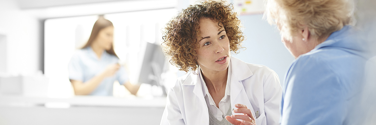 A pharmacist talks with a patient