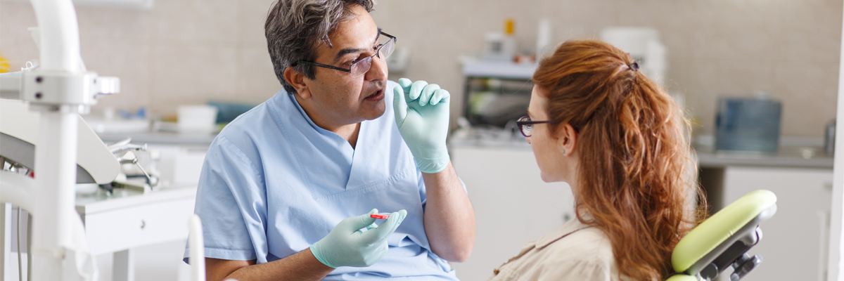 Dentist talking to a patient