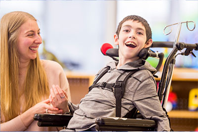 Boy and carer laughing