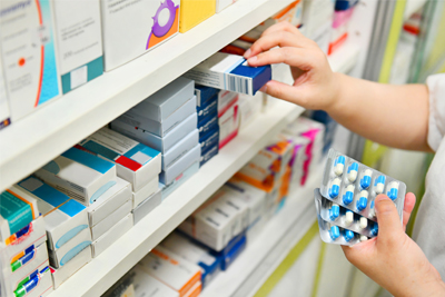 Pharmacist checking medicines