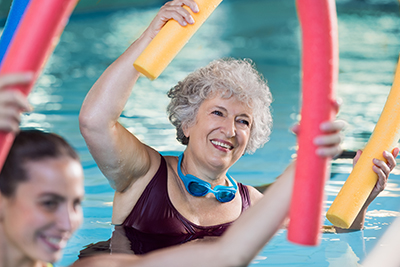 Smiling senior woman doing aqua fitness