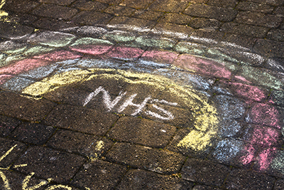 Rainbow with NHS written below it