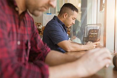 Two people sitting at a desk typing