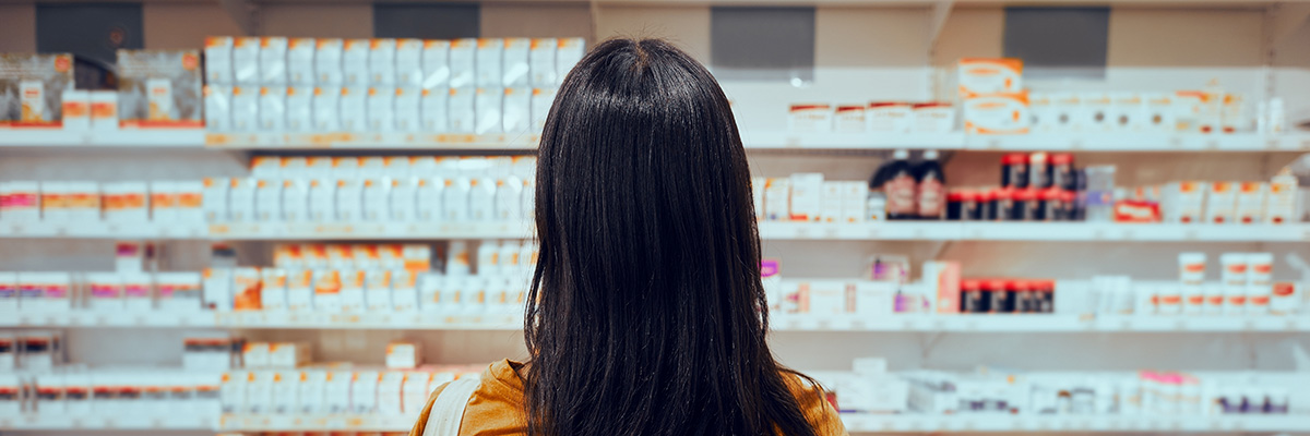 Person standing in front of a pharmacy counter