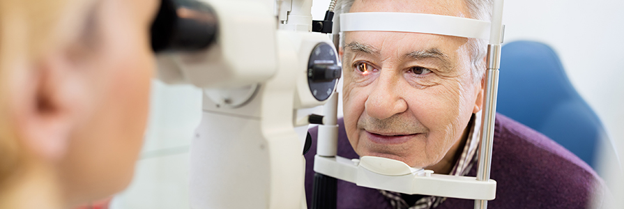 Female eye specialist examines eyes of a patient