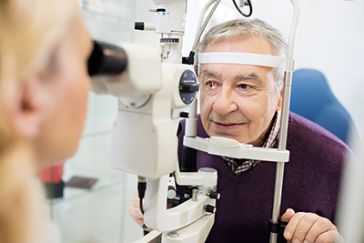 Female eye specialist examines and man's eyes
