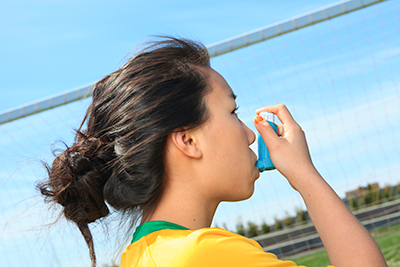Female taking an inhaler