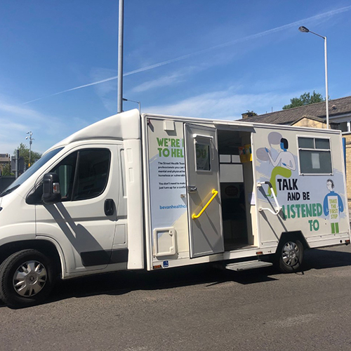 A white van parked, with the words "Talk and be listened to" on the side