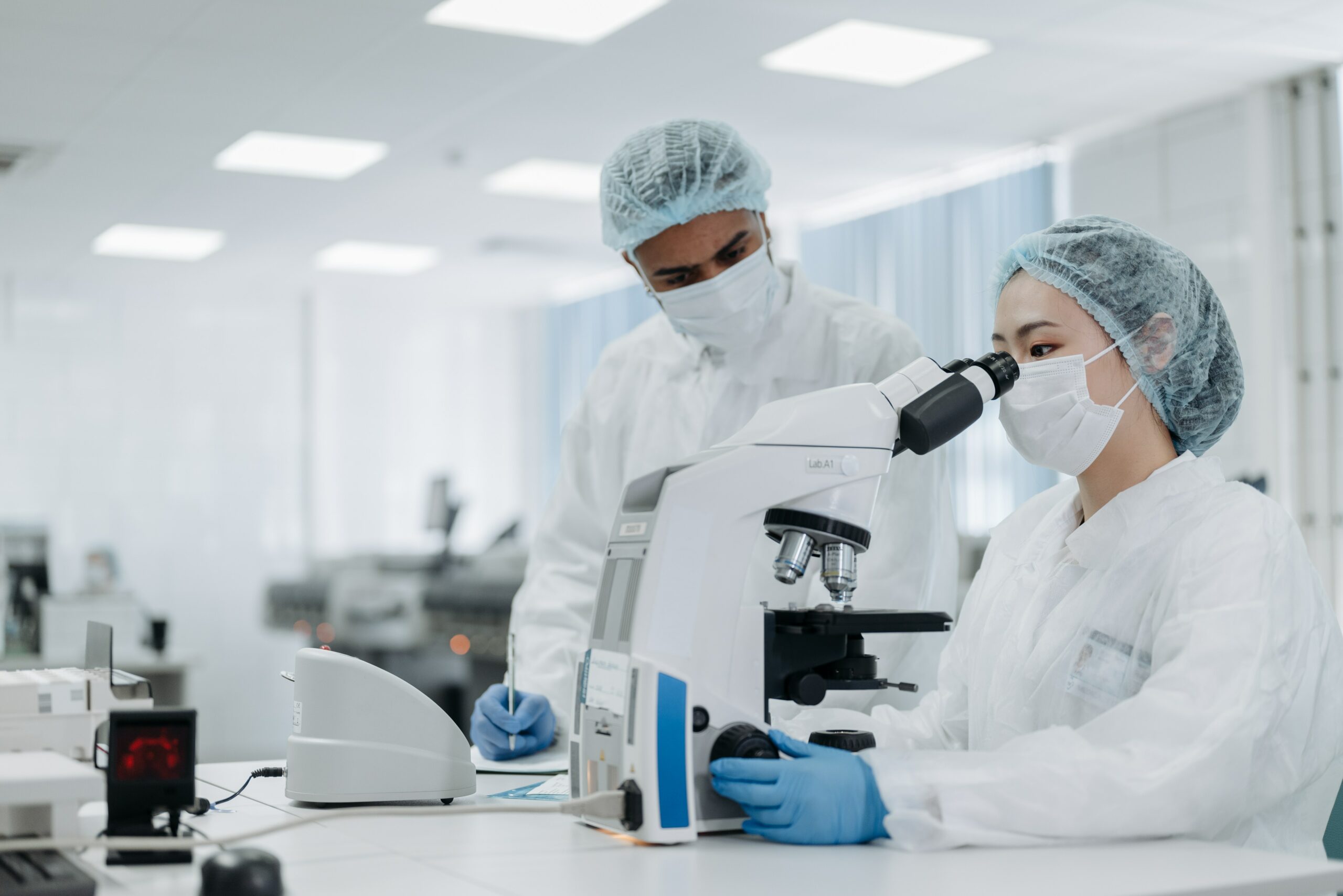 Scientists in lab using microscope