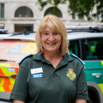 Photo of Jenny West standing in front of an ambulance