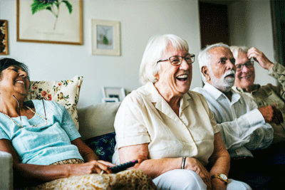 Four elderly people laughing