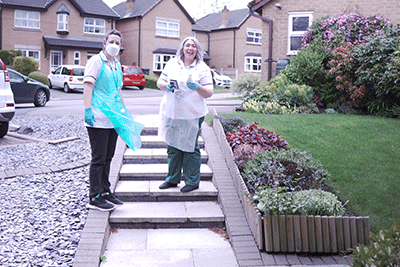 Two community health professionals on a patients doorstep