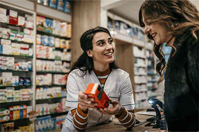 Pharmacist showing a patient some medicine from over the counter