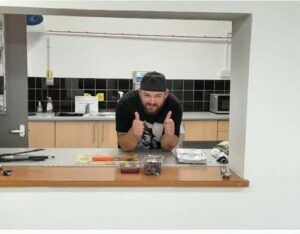 A person sitting at a kitchen counter 