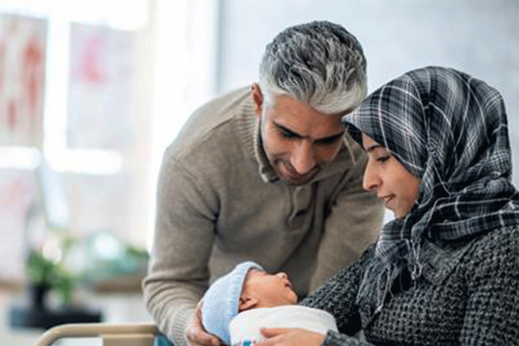 Parents holding a a new born baby