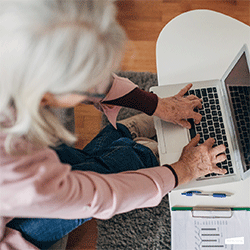A woman typing on a laptop