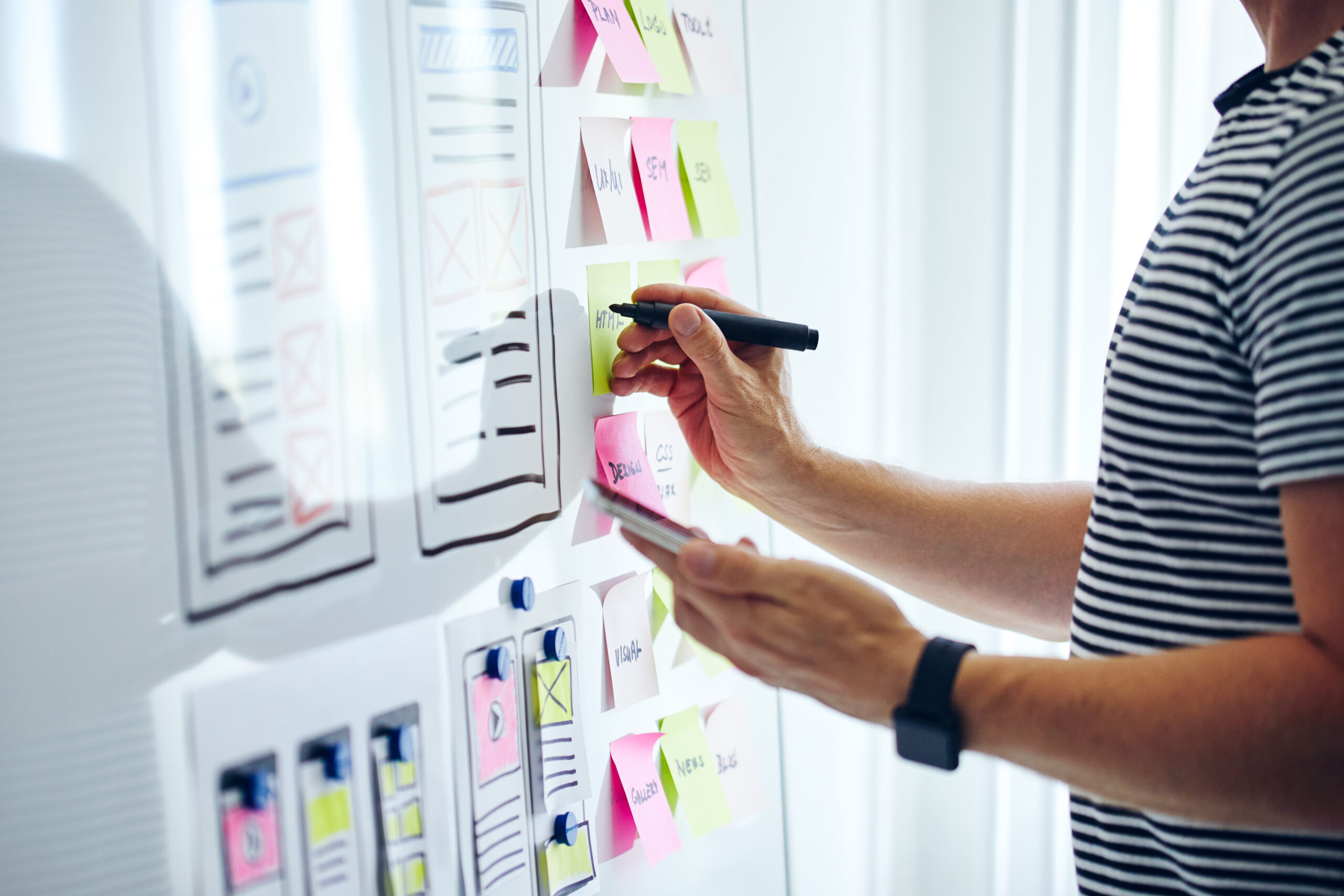 Web designer planning website ux app development with marker pen