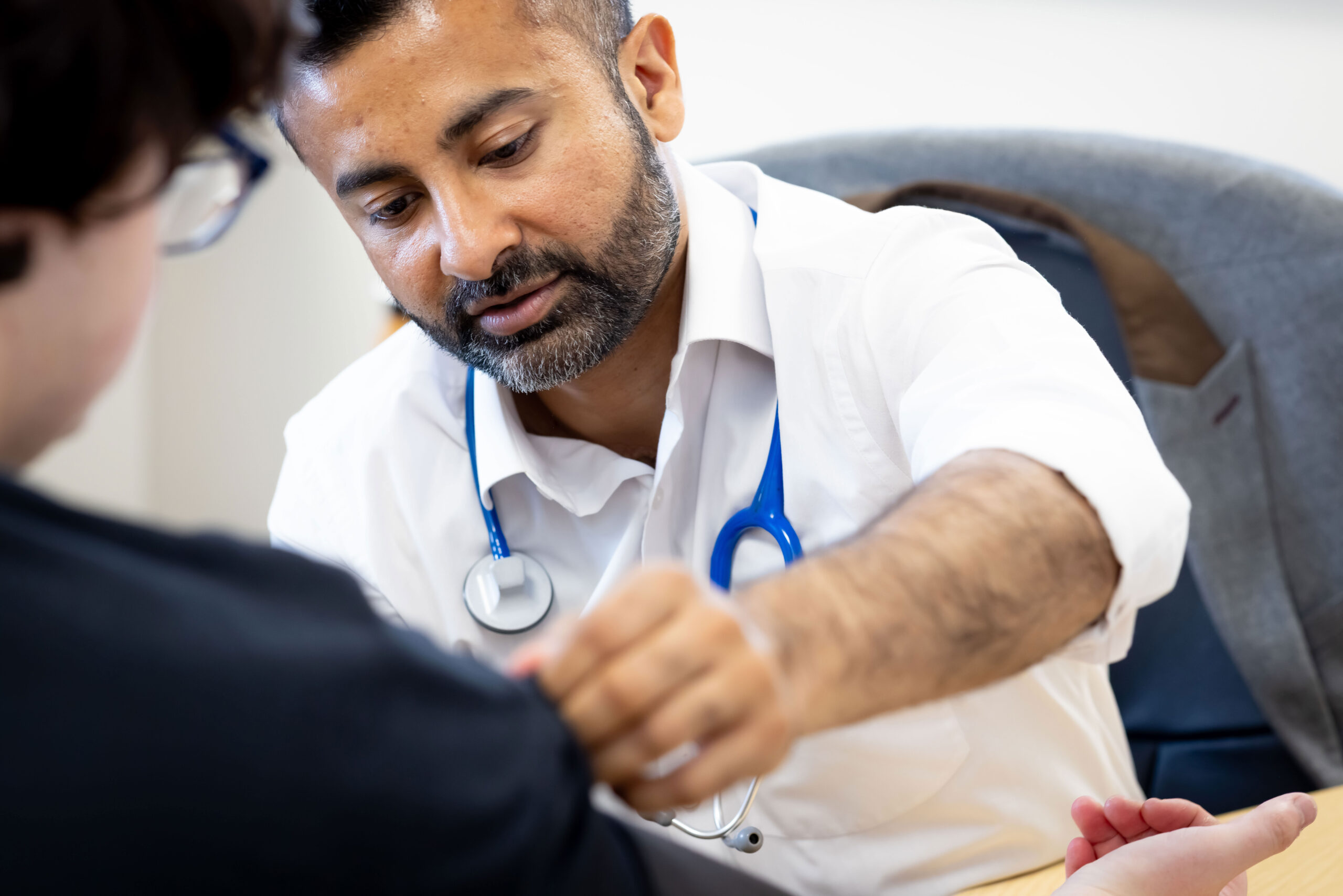 GP taking a blood pressure test.